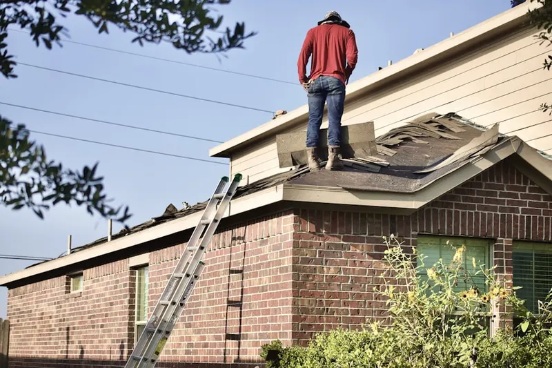 Professional roofer working on a residential roof in Blackburn Village